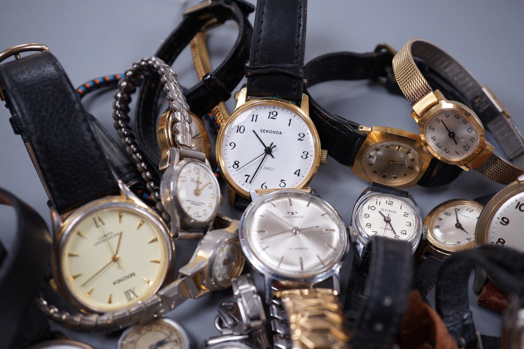 Seven assorted gentleman's wrist watches including steel Ingersoll and steel Technics, Adano and Sekonda and twelve assorted lady's wrist watches including Timex, Editia and a yellow metal Winegartens.